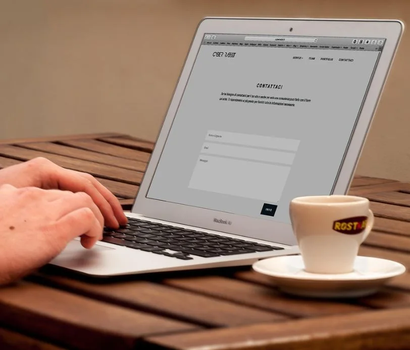 Laptop on a desk showing a website project dashboard